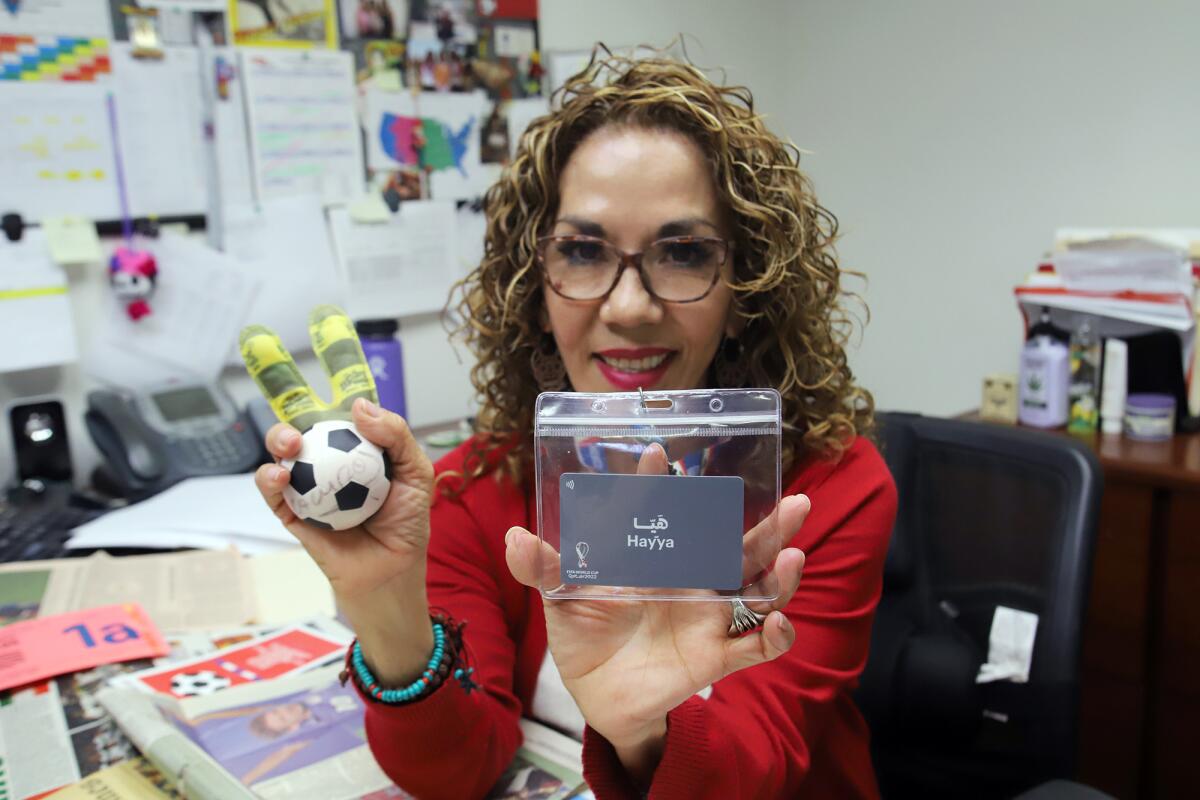 Bertha Alicia Guzman, of Torrance, is all smiles as she shows her FIFA World Cup Qatar Hayya card.