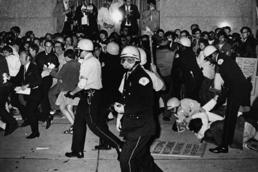 FILE - In this Aug. 29, 1968, file photo, Chicago Police attempt to disperse demonstrators outside the Conrad Hilton, the downtown headquarters for the Democratic National Convention in Chicago. During the convention, hundreds of demonstrators waged war with police and National Guardsmen on the streets of Chicago. (AP Photo/Michael Boyer, File)