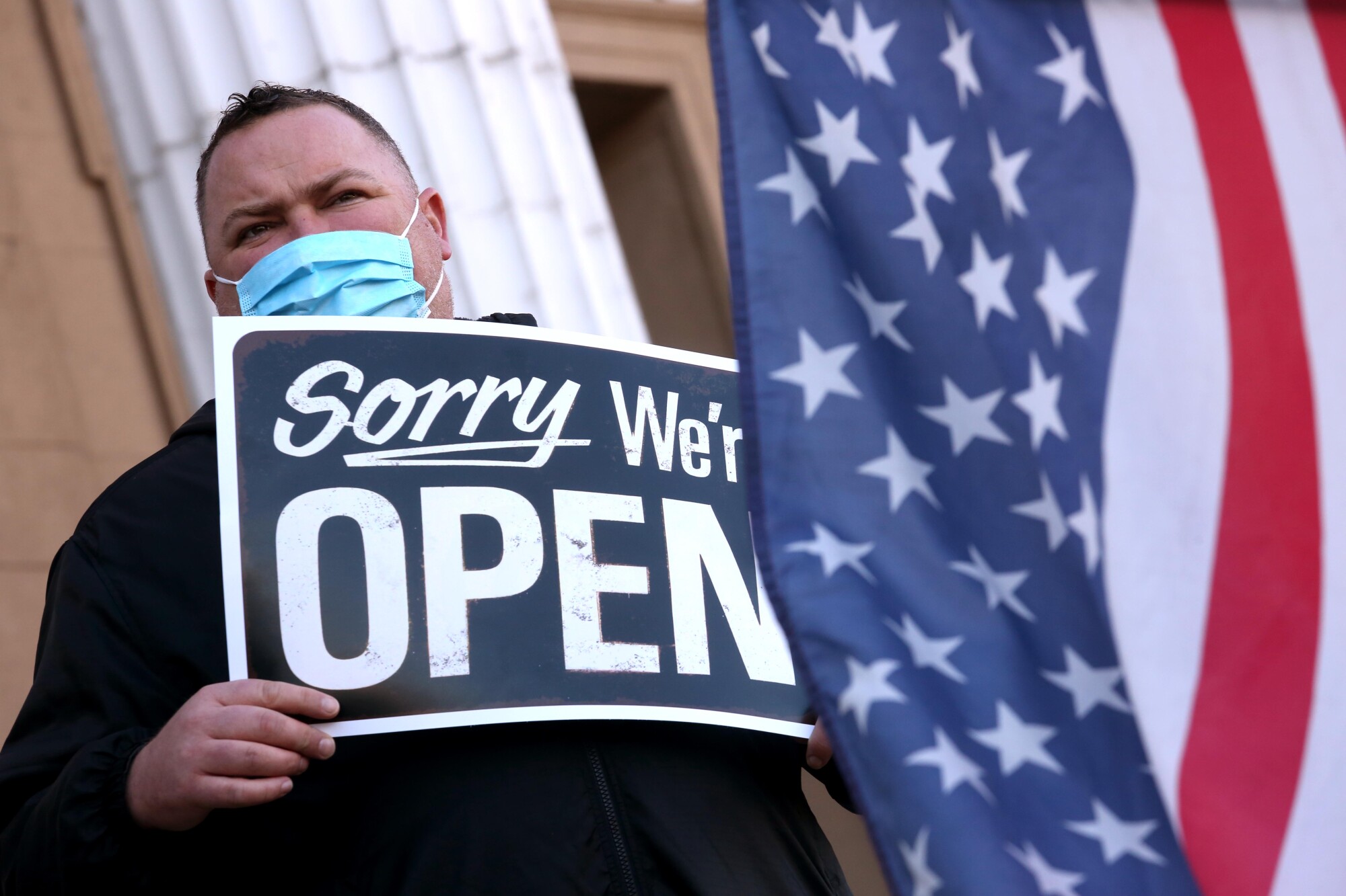 Michael Midgley joins other Stockton business owners who make a statement for keeping their businesses open.