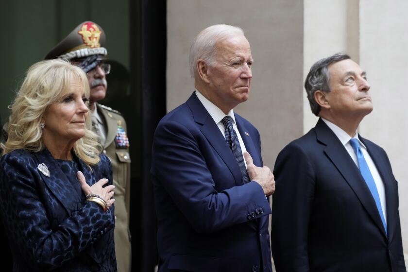 U.S. President Joe Biden, center, and first lady Jill Biden, left, take part in a ceremony with Italy's Prime Minister Mario Draghi at the Chigi Palace in Rome, Friday, Oct. 29, 2021. A Group of 20 summit scheduled for this weekend in Rome is the first in-person gathering of leaders of the world's biggest economies since the COVID-19 pandemic started. (AP Photo/Gregorio Borgia)