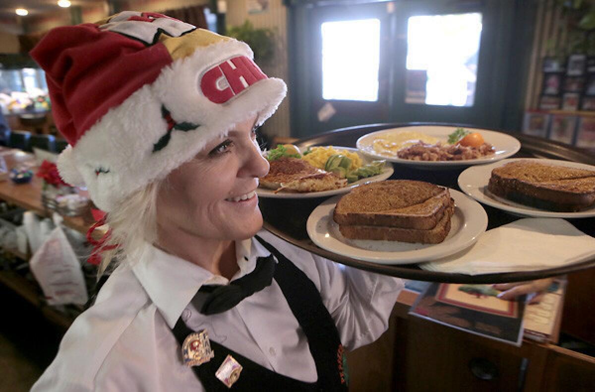 Julie Butkus delivers breakfast on a recent morning shift at Peppertree Cafe.