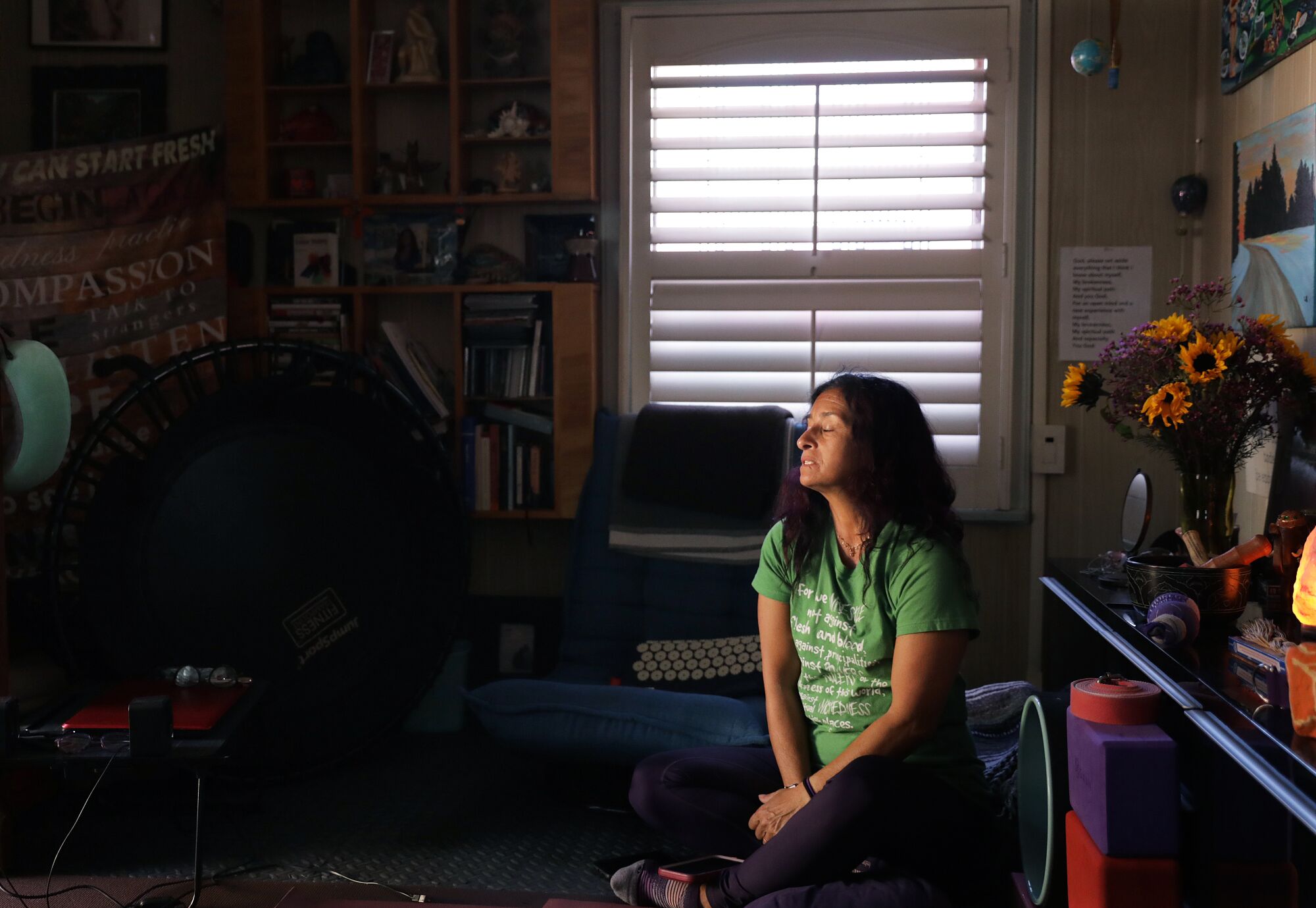 A woman sits on the floor