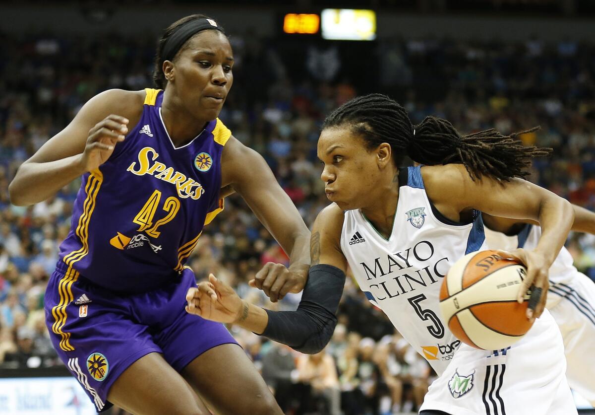 Sparks center Jantel Lavender, left, defends Minnesota guard Tan White during the second half of L.A.'s 71-63 win over the Lynx in Minneapolis.