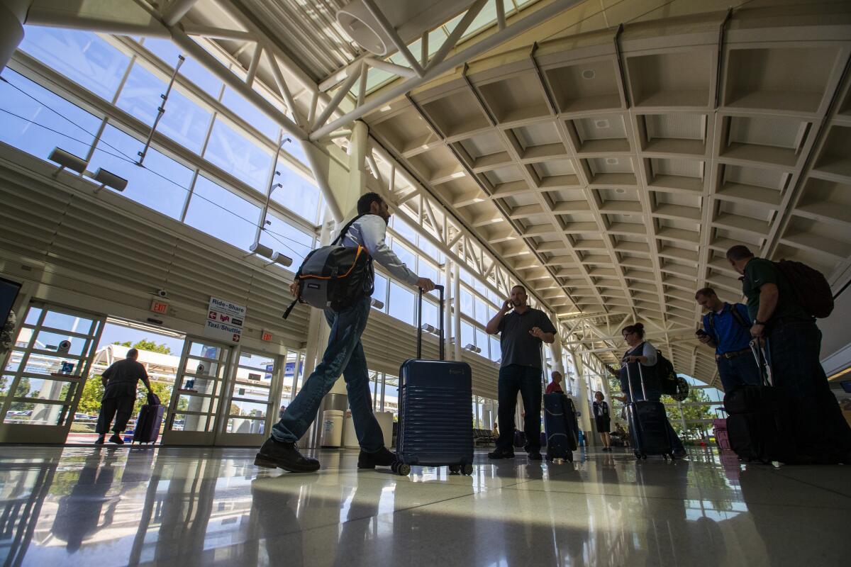 People walk through an airport