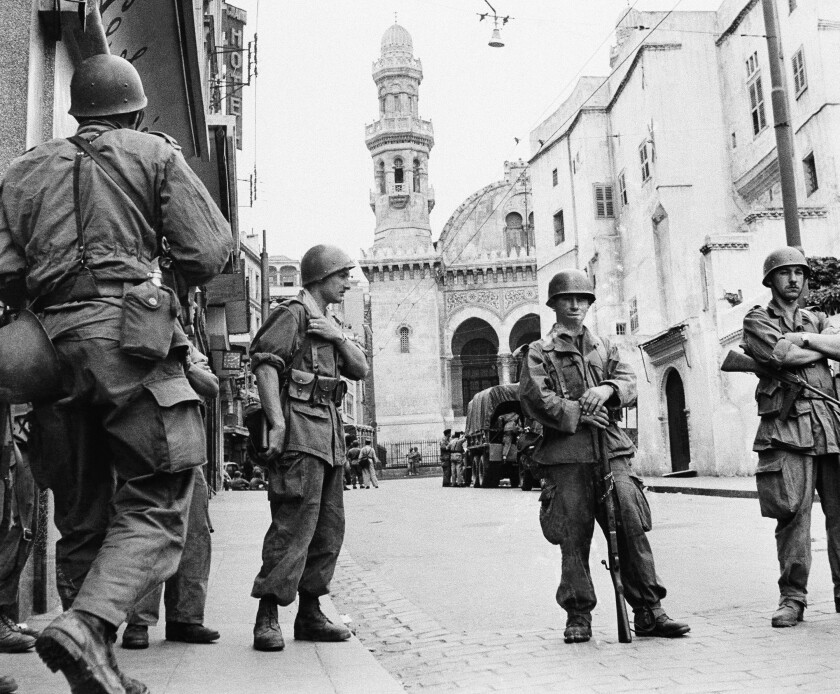 FILE - In this May 27, 1956 file photo, French troops seal off Algiers' notorious casbah, 400-year-old teeming Arab quarter. French President Emmanuel Macron announced a decision to speed up the declassification of secret documents related to Algeria's seven-year war of independence from 1954 to 1962. (AP Photo, File)