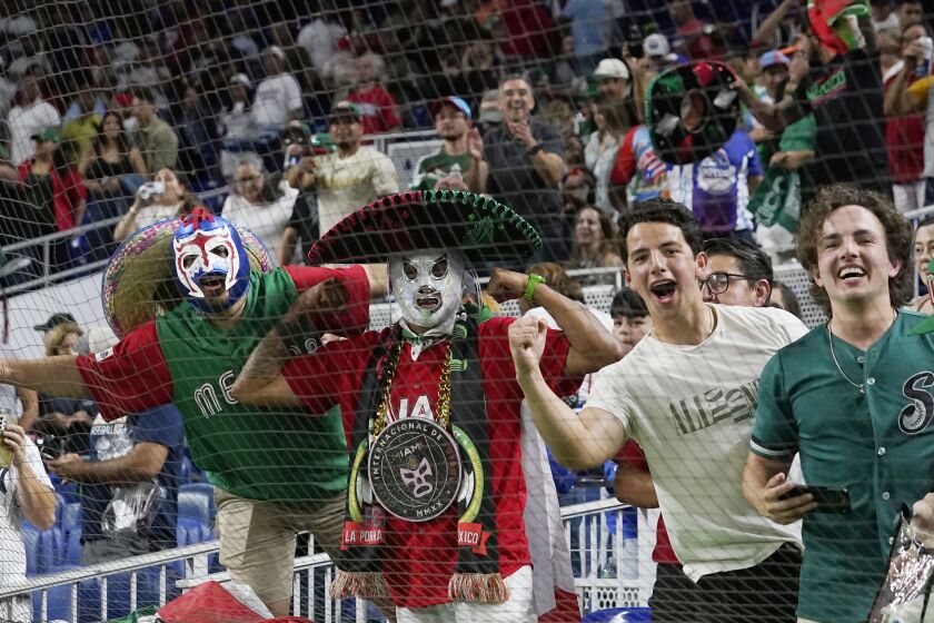 Mexico fans celebrate the 5-4 win over Puerto Rico during a World Baseball Classic game, Friday, March 17, 2023, in Miami. (AP Photo/Marta Lavandier)