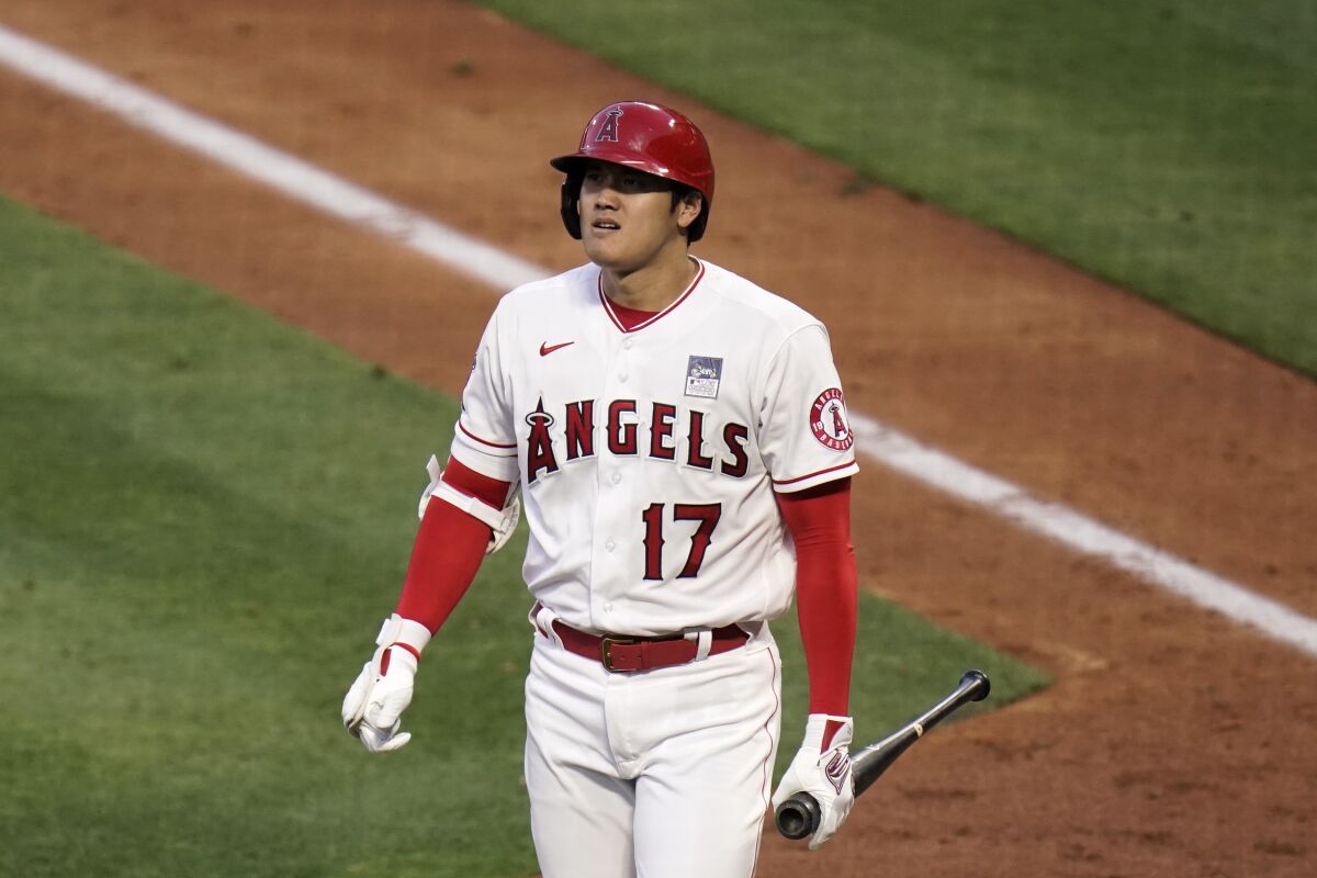 Angels' Shohei Ohtani heads to the dugout after striking out.