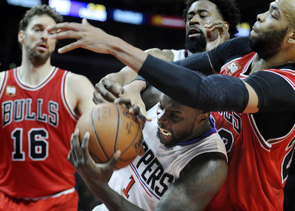 Clippers forward Lance Stephenson (1) fights for the rebound between Bulls forwards Pau Gasol (16) and Taj Gibson, right.