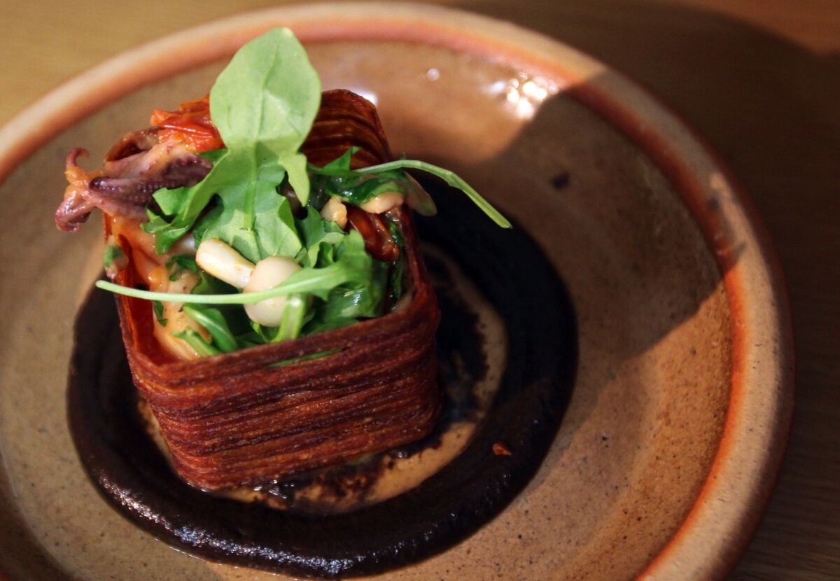 One of Scratch Bar's signature presentations is its Squid in a Box. The box is fashioned from fried potato, and the construction rests on a tar-black purée of charred eggplant.