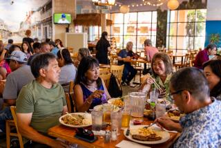 LOS ANGELES, CA - AUGUST 11, 2023: Diners fill up Back Home in Lahaina, a Hawaiian restaurant in Carson popular spot with local Hawaiians, as it hosts one of tehir regular live music events on Friday, Aug. 11, 2023 in Carson, CA. The restaurant encouraged its patrons to contribute to a fund for the victims of the devastating fire, one of three that swept through Maui, and near leveled the historic town of 12,000 Lahaina on Wednesday, Aug. 9, 2023, killing 80 people as counted by Saturday. (Silvia Razgova / For The Times)