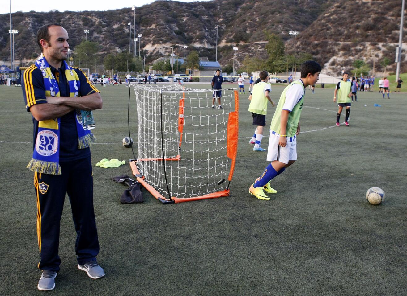 Los Angeles Galaxy's Landon Donovan watches children participate in a L.A. Galaxy-sponsored soccer clinic at the Glendale Sports Complex in Glendale on Thursday, August 29, 2013. About 150 AYSO players participated in the event.