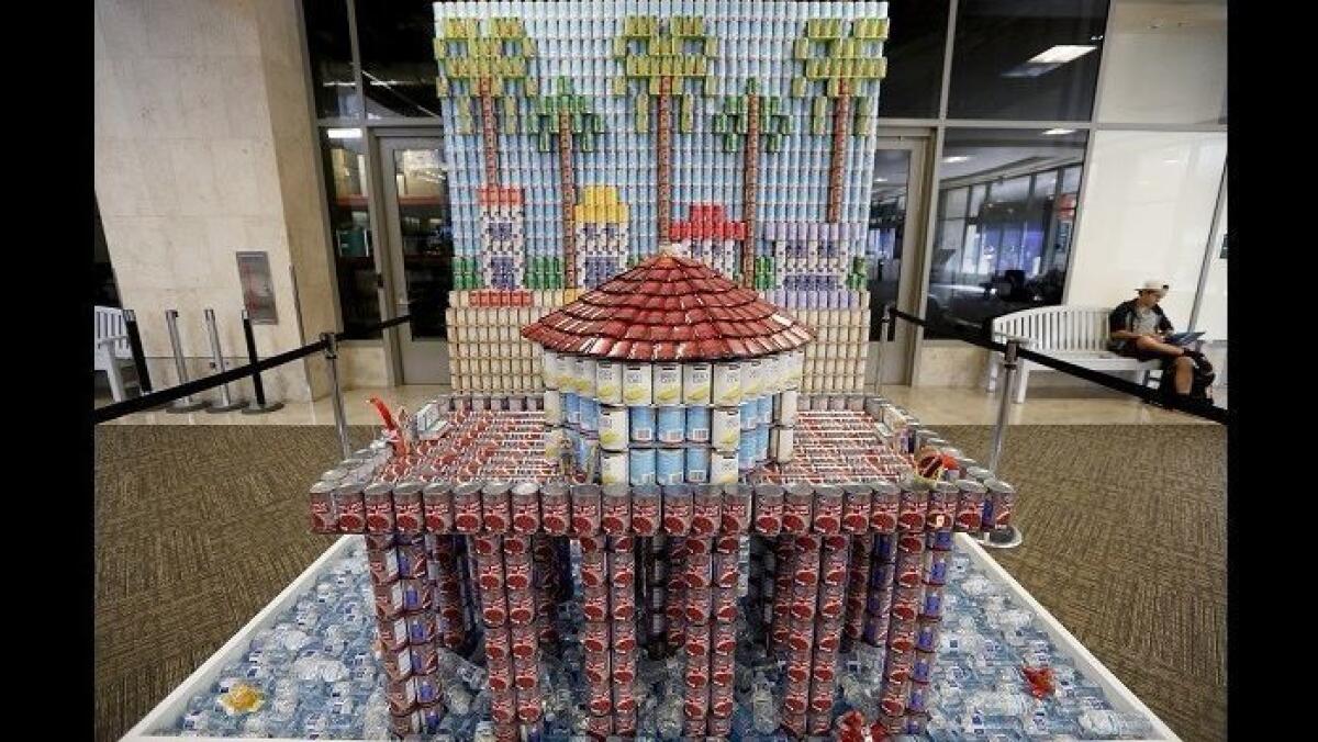 A sculpture by Fluor is displayed at John Wayne Airport on Friday as part of the annual Canstruction Orange County design-build competition. The structure contains 5,025 cans.