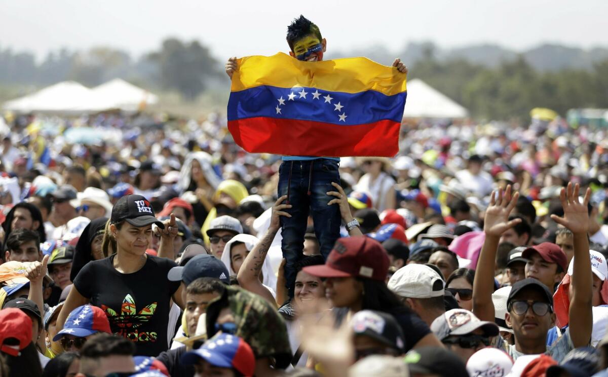 A child holds a Venezuelan flag during the Venezuela Aid Live concert on the Colombian side of Tienditas International Bridge on the outskirts of Cucuta, Colombia.