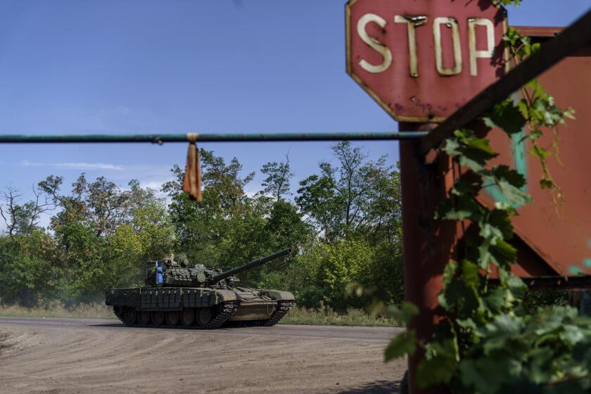 A Ukrainian military tank drives down the road in the Donetsk region, eastern Ukraine, Sunday, Aug. 21, 2022. (AP Photo/David Goldman)