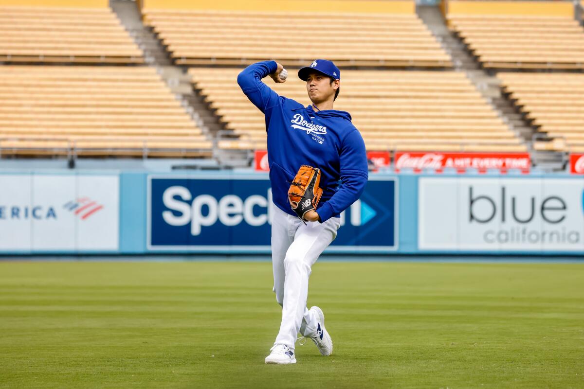 Shohei Ohtani throws before a game between the Dodgers and Angels at Dodger Stadium on March 25.
