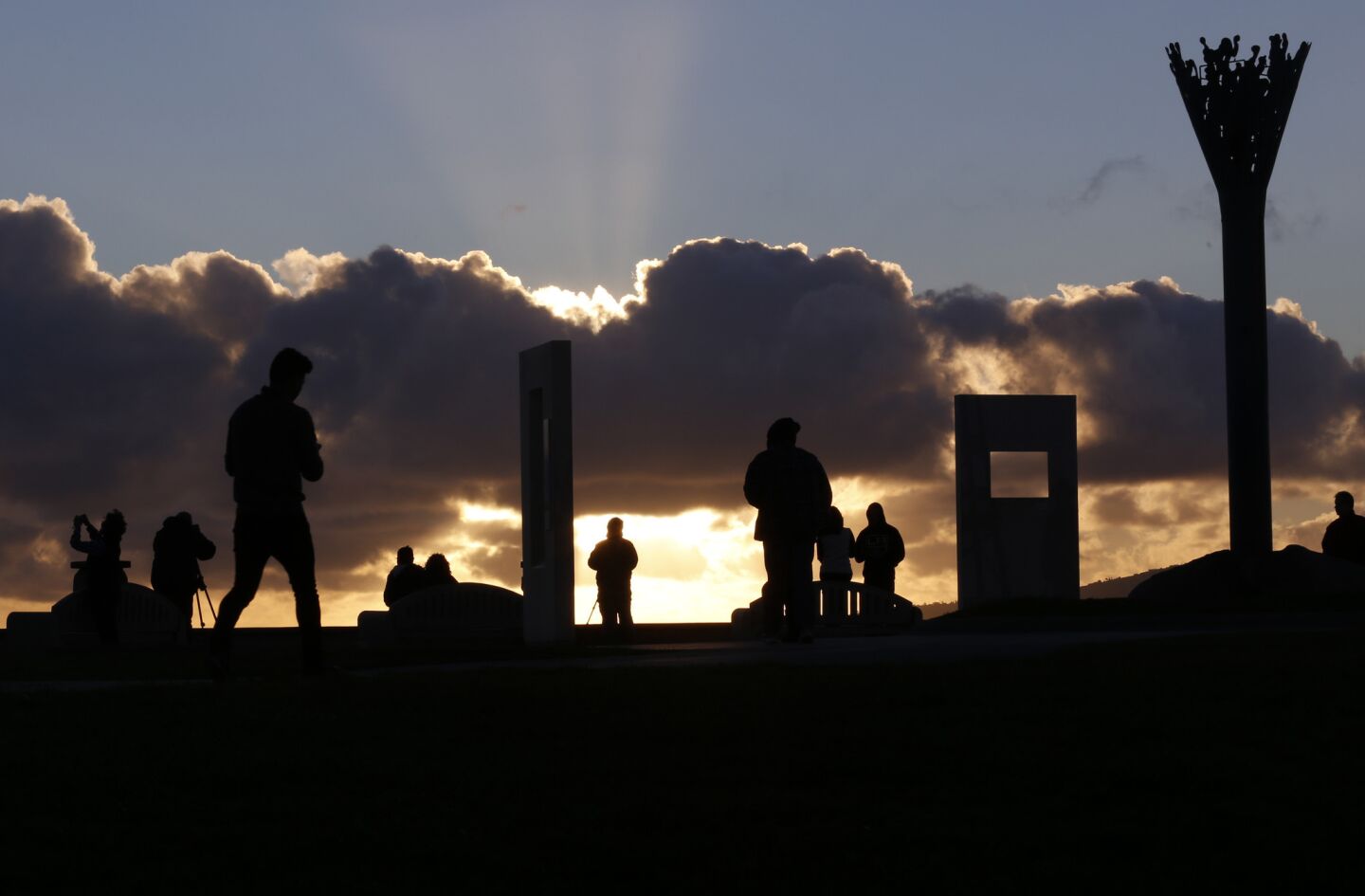 People enjoy the sunset at Hill Top Park in Signal Hill.