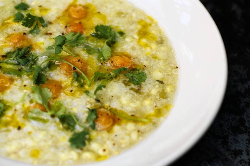 Gjelina's sweet corn soup comes with confit cherry tomato and cilantro.