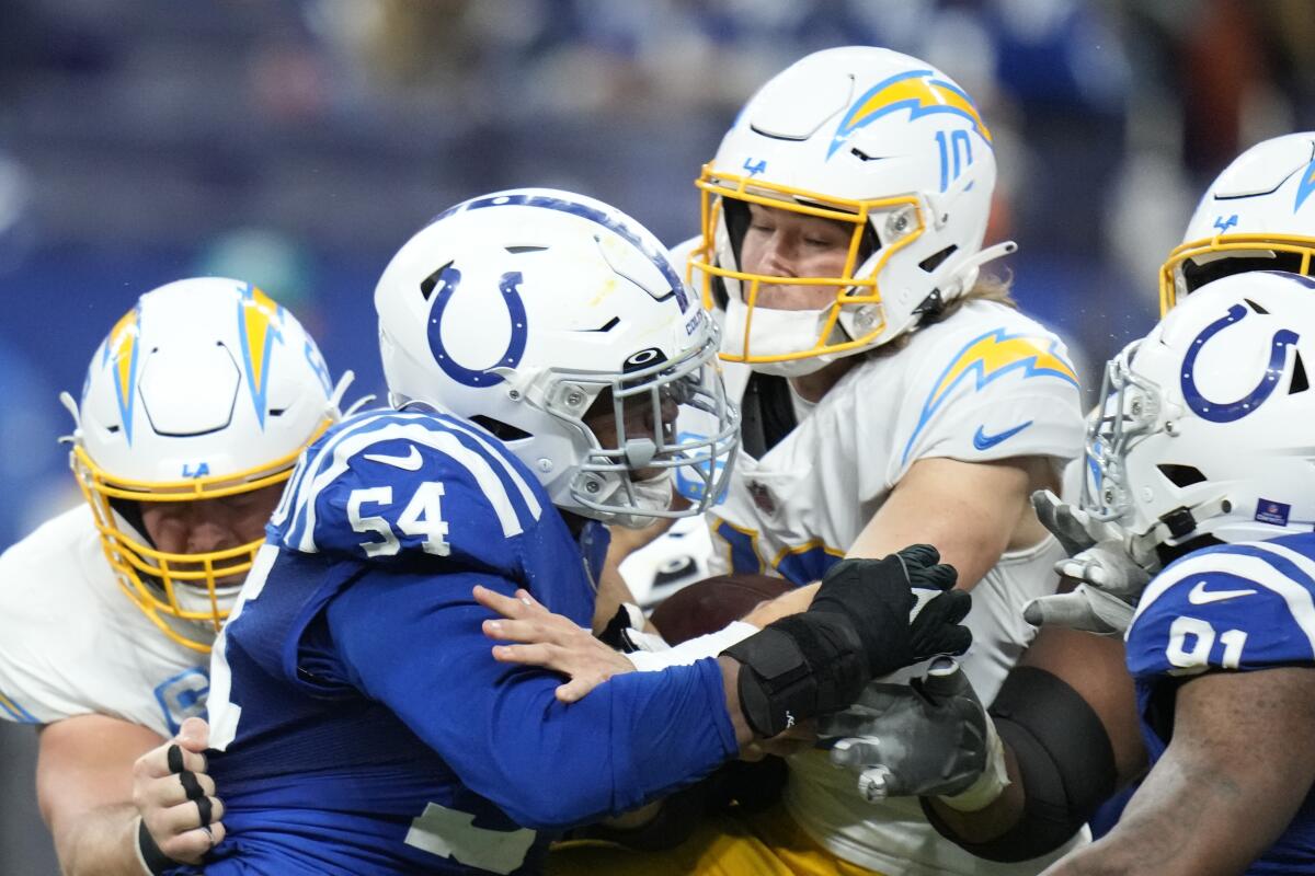Chargers quarterback Justin Herbert fumbles the ball as he is sacked by the Colts' Dayo Odeyingbo.