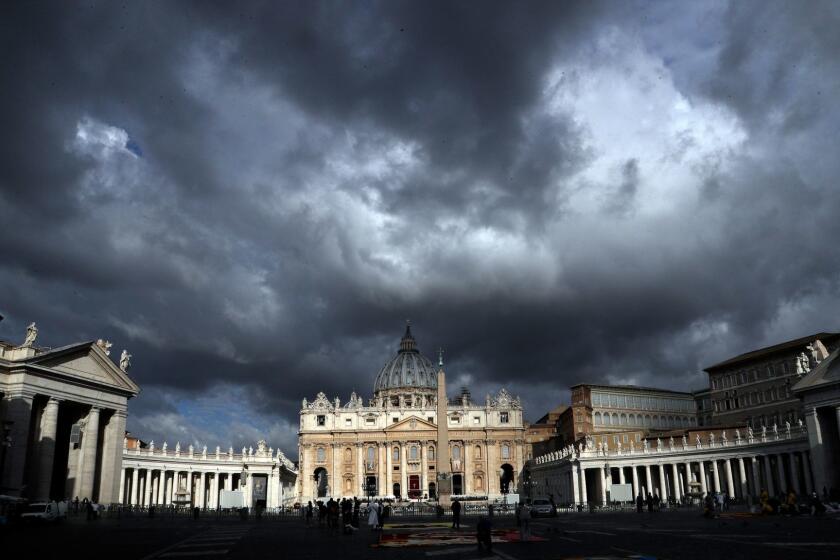 Clouds hang over St. Peter's Basilica, at the Vatican, Thursday, June 29, 2017. The Catholic Archdiocese of Sydney says Vatican Cardinal George Pell will return to Australia to fight sexual assault charges as soon as possible. (AP Photo/Gregorio Borgia)