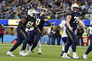 Los Angeles Chargers quarterback Justin Herbert (10) fumbles as he is hit by Baltimore Ravens linebacker Jadeveon Clowney during the second half of an NFL football game Sunday, Nov. 26, 2023, in Inglewood, Calif. Baltimore recovered the ball on the play. (AP Photo/Ashley Landis)