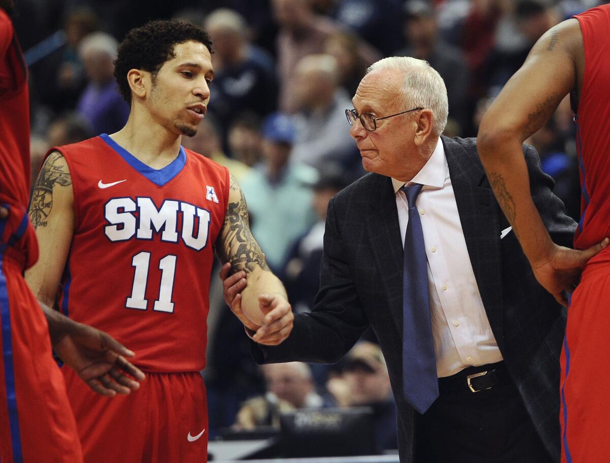 SMU head coach Larry Brown talks with leading scorer Nic Moore during a game. SMU will face Brown's former team, UCLA, in the NCAA tournament.