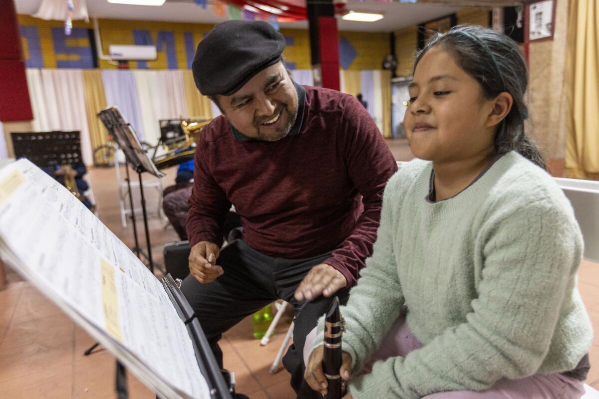 Director/founder Estanislao Maqueos instructs Melanie Juarez as she practices clarinet at Maqueos Music Academy