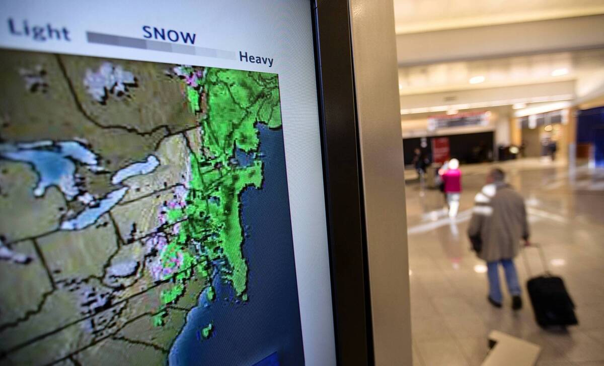 The most common exceptions used by insurers to reject travel insurance claims are illnesses involving a pre-existing medical condition, pregnancy or childbirth, losing a job or having a business meeting canceled, according to the National Consumer League. Above, a television screen shows the radar from a storm moving through the East Coast as passengers walk through Hartsfield-Jackson Atlanta International Airport last week.