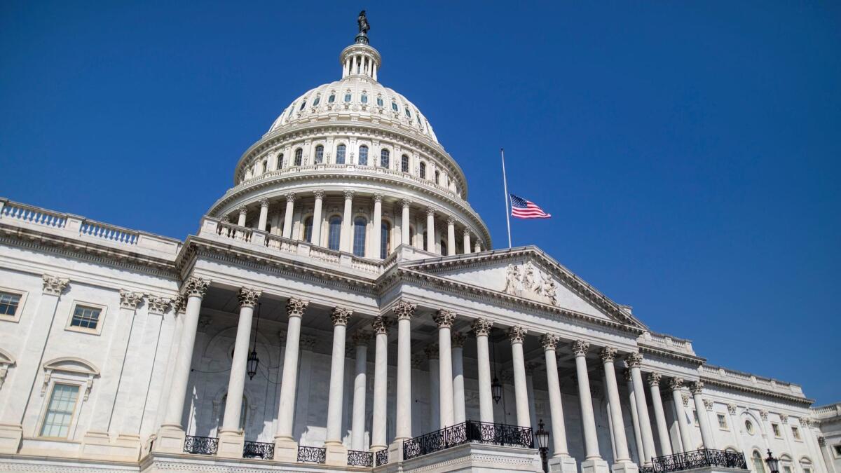 The flag flies at half-staff in front of the U.S. Capitol in Washington on Sunday in honor of Sen. John McCain (R-Ariz.), who died at his home in Cornville, Ariz., Saturday at the age of 81.