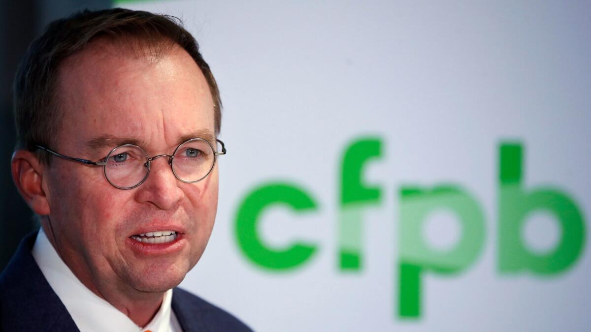 Mick Mulvaney speaks during a news conference after his first day as acting director of the Consumer Financial Protection Bureau in Washington on Nov. 27