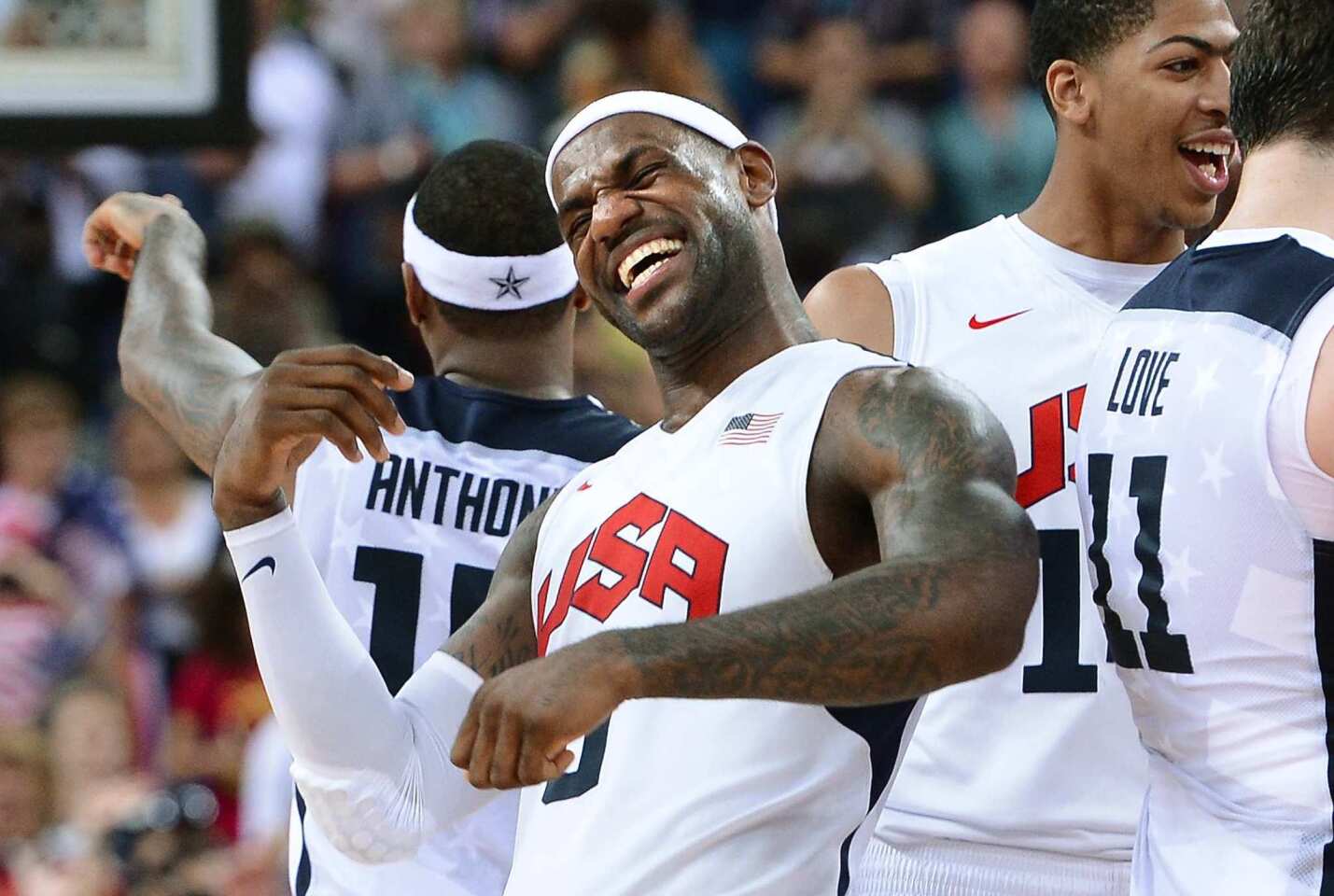 LeBron James celebrates with teammates after defeating Spain in the men's basketball final to win the gold medal.