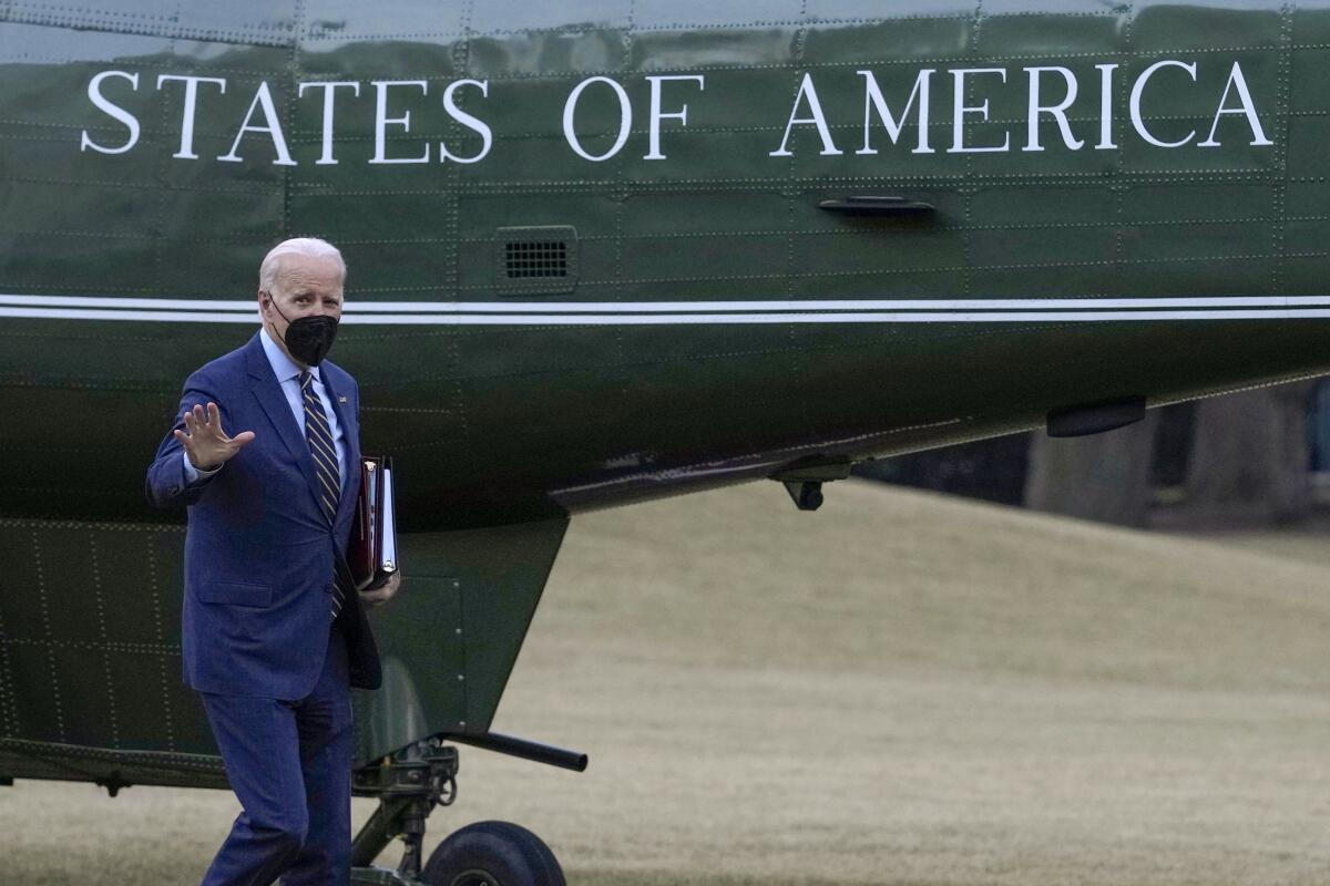 President Biden waving as he walks away from Marine One