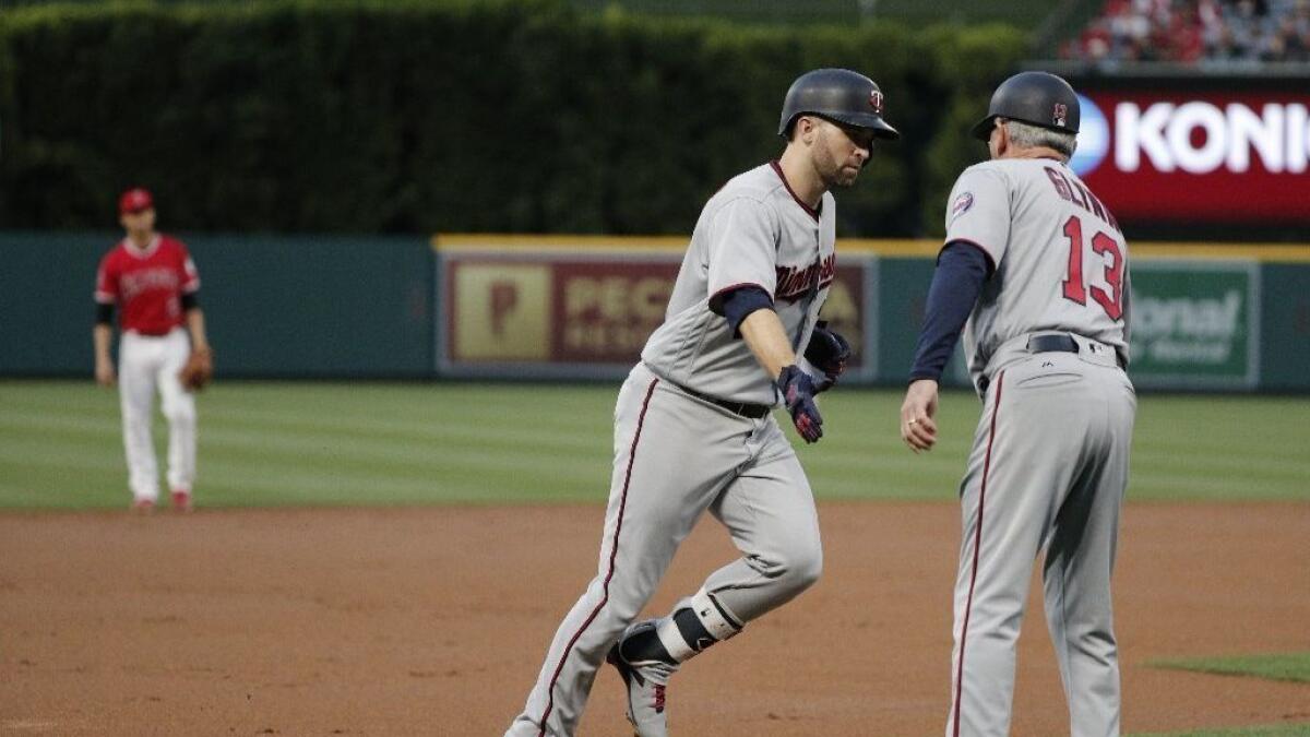 Twins second baseman Brian Dozier rounds the bases after hitting a solo home run during the first inning of a game Friday at Angel Stadium.