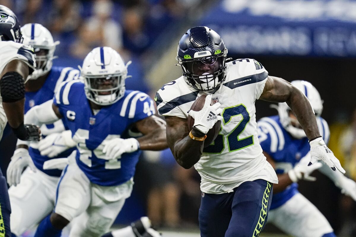 Seattle Seahawks running back Chris Carson (32) runs against the Indianapolis Colts in the first half of an NFL football game in Indianapolis, Sunday, Sept. 12, 2021. (AP Photo/Charlie Neibergall)