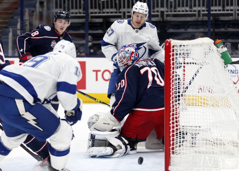 Tampa Bay Lightning forward Barclay Goodrow (19) scores past Columbus Blue Jackets goalie Joonas Korpisalo (70) in front of Blue Jackets defenseman Zach Werenski (8) and Lightning forward Yanni Gourde (37) during the first period an NHL hockey game in Columbus, Ohio, Thursday, April 8, 2021. (AP Photo/Paul Vernon)