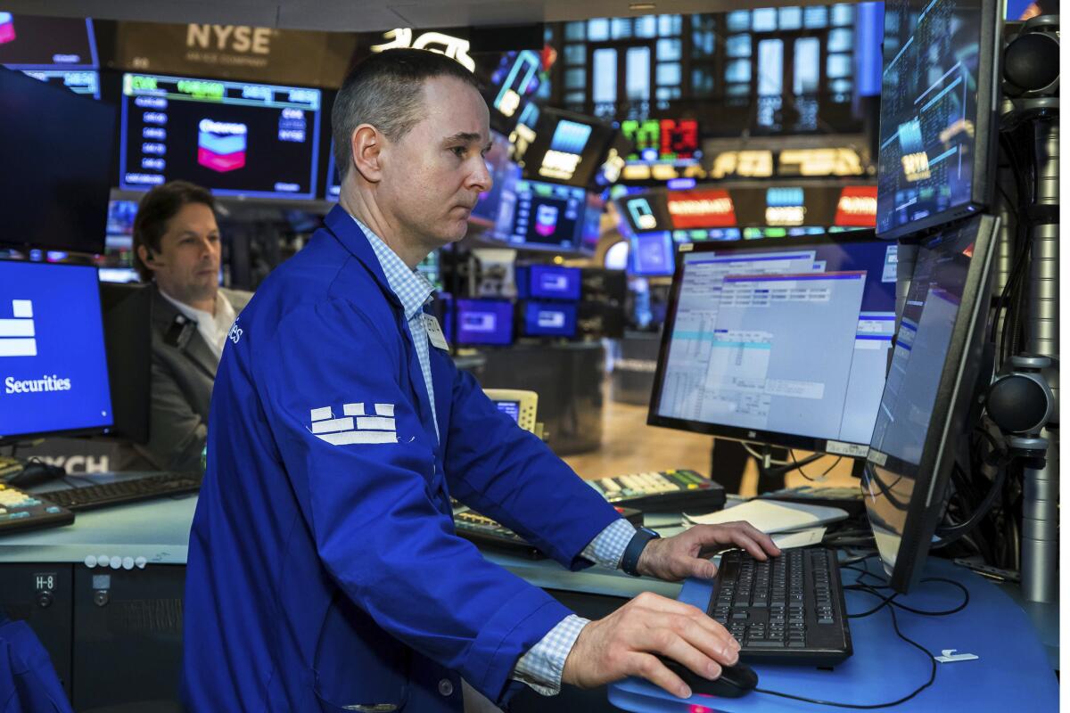 A man works at his post on the trading floor of the New York Stock Exchange. 