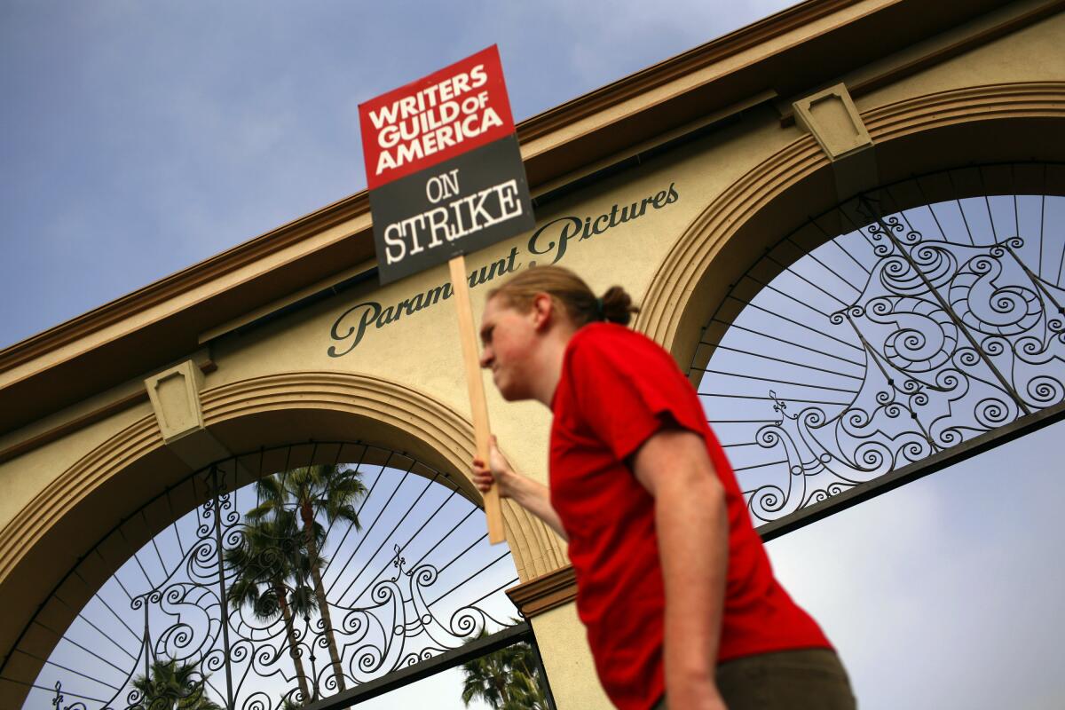 A protester walks the picket line outside Paramount Studios