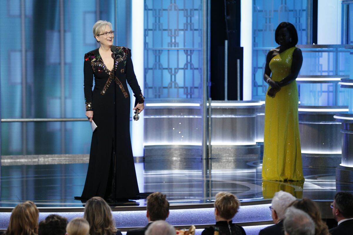 Meryl Streep accepts the Cecil B. DeMille Award as presenter Viola Davis, right, looks on.