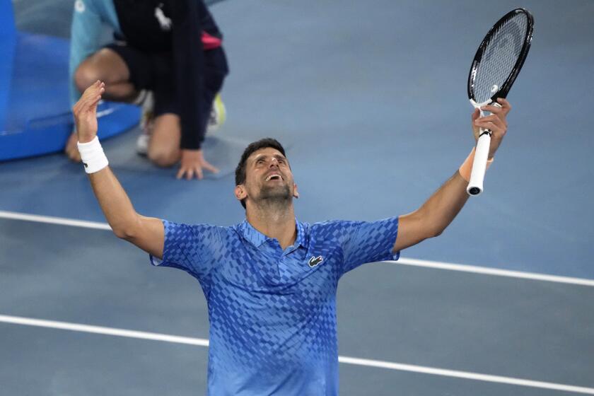 Novak Djokovic celebrates on Sunday after winning the Australian Open championship and 22nd Grand Slam title overall.