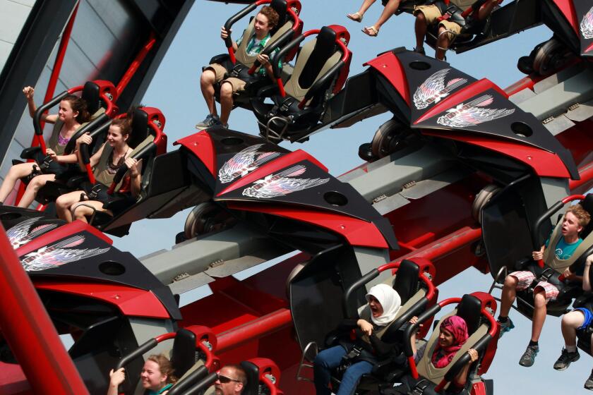 Guests defy gravity as they ride on the revolutionary X Flight Roller Coaster at Six Flags Great America in Gurnee, Monday, June 10, 2013.