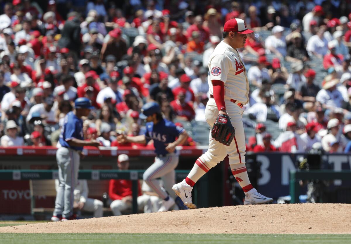 Angels starting pitcher José Suarez walks back to the mound after giving up a two-run home run.