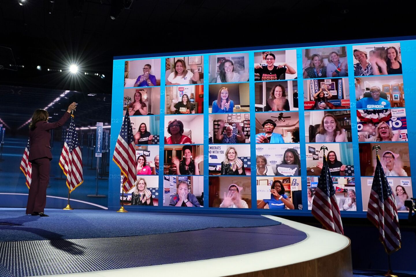 Aug. 19, 2020: Democratic vice presidential candidate Sen. Kamala Harris waves to supporters on a video monitor