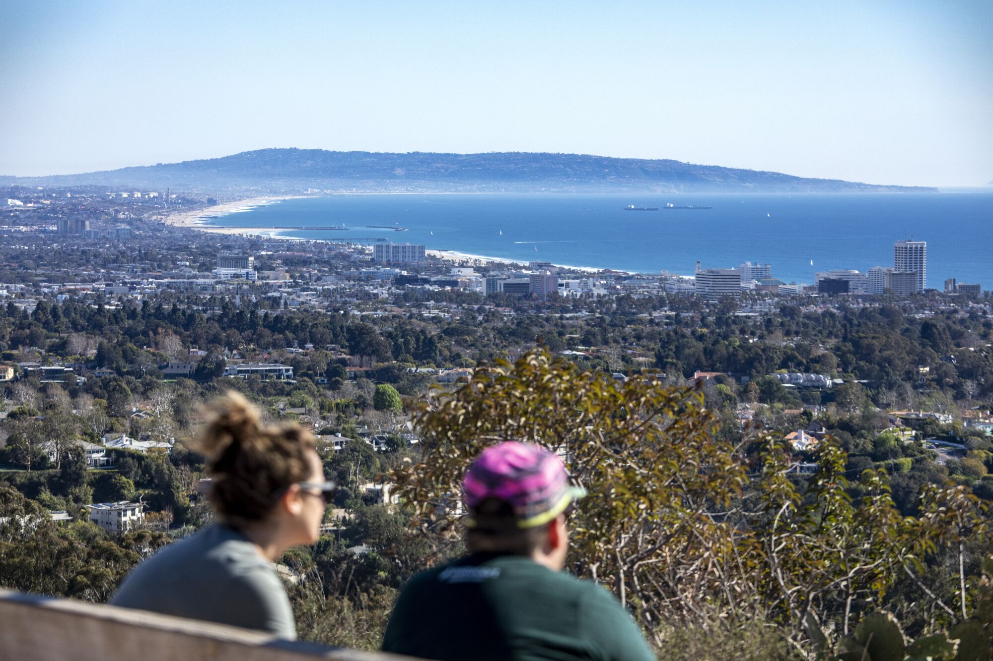 Hikers take in the view of Santa Monica Bay from Inspiration Point in Will Rogers State Park State Historic Park.