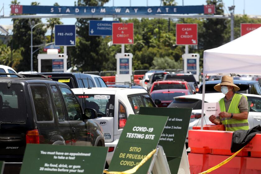 LOS ANGELES, CA - JUNE 09, 2020 - - Traffic flows once again into the Dodgers Stadium parking lot for a free drive-up test for COVID-19 in Los Angeles on June 9, 2020. The testing site was closed for a few days during protests over the death of George Floyd. (Genaro Molina / Los Angeles Times)