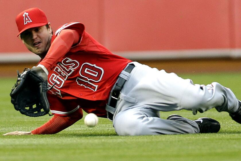 Angels left fielder Grant Green can't make a sliding catch on a line drive hit by Oakland's Jed Lowrie in the first inning Friday night in Oakland.