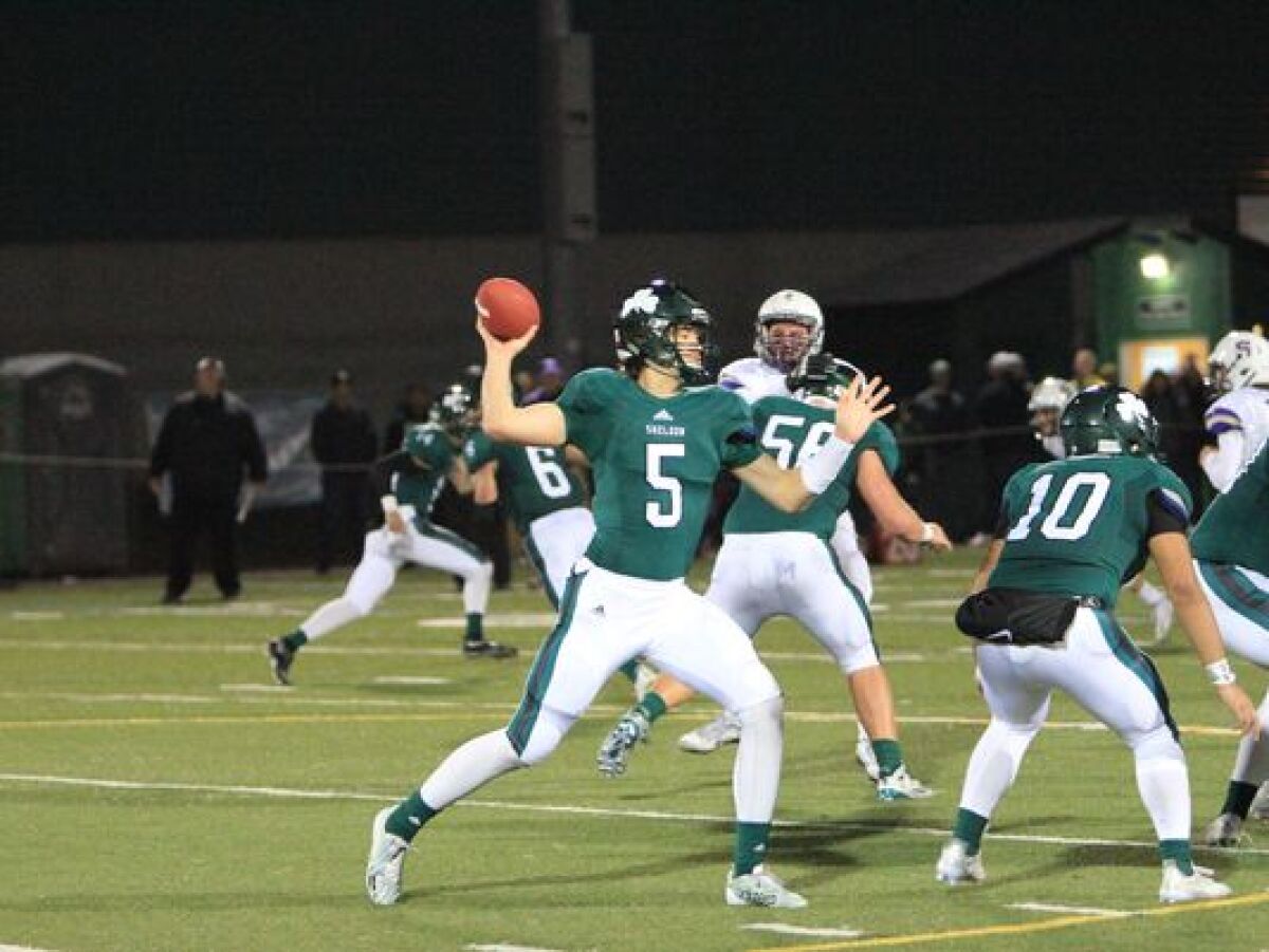 Justin Herbert looks to throw a pass during a game for Sheldon High (Eugene, Ore.).