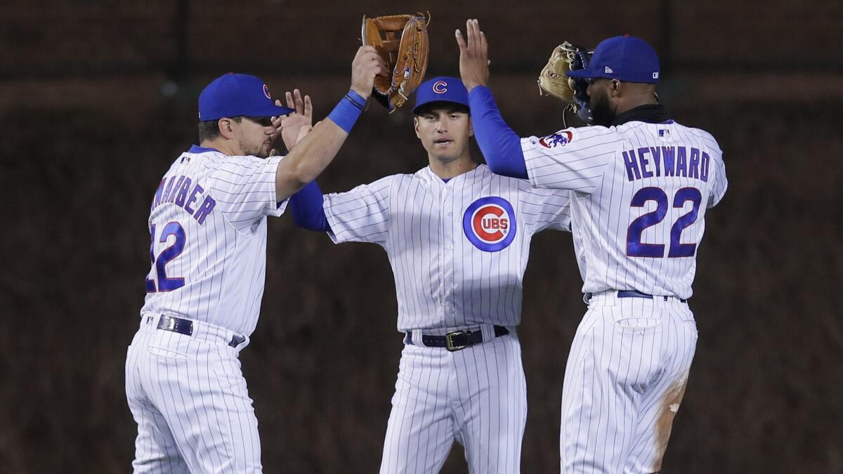 Outfielders Kyle Schwarber, Albert Almora Jr. and Jason Heyward, from left, celebrate the Chicago Cubs' 7-2 victory over the Dodgers on Tuesday in Chicago.