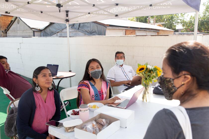 LOS ANGELES, CA - October 30, 2021: CIELO members give out food pantry boxes to community members in Los Angeles, California on Saturday, October 30, 2021. CREDIT: Allison Zaucha for the Los Angeles Times