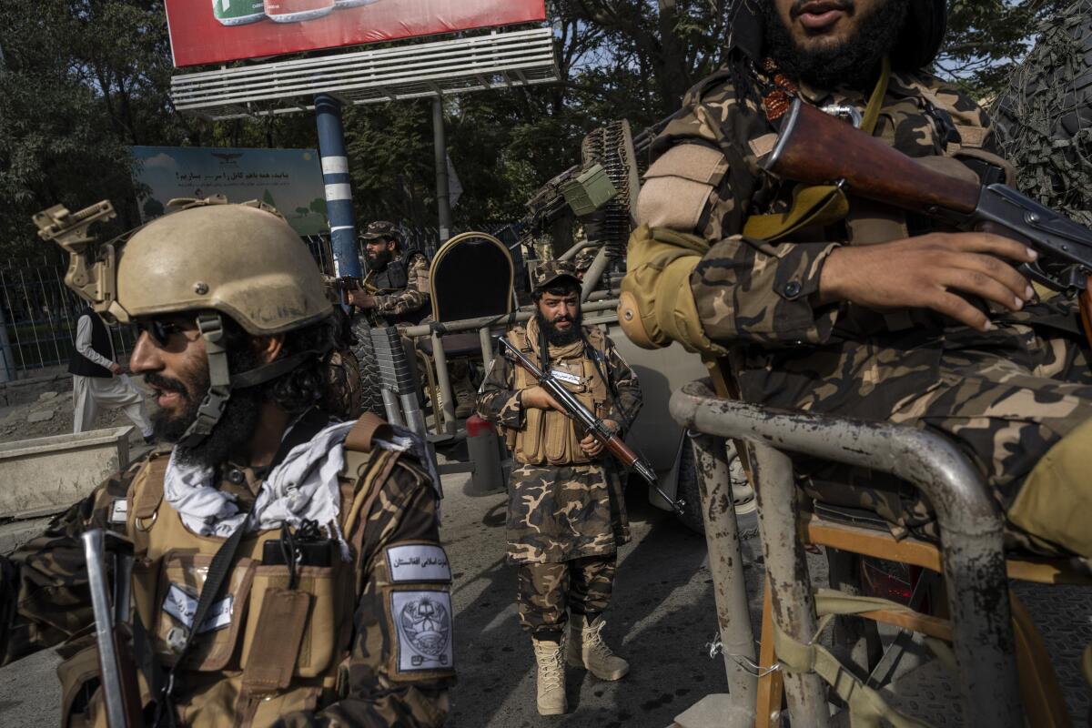 Fighters of the Haqqani network secure an area during a demonstration