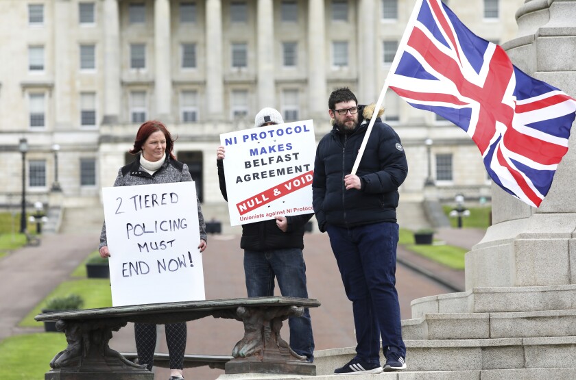 Loyalist protesters opposed to the Northern Ireland Protocol on Brexit makes his political point during a protest outside parliament buildings, Stormont, Belfast, Northern Ireland, Thursday, April 8, 2021 .(AP Photo/Peter Morrison)