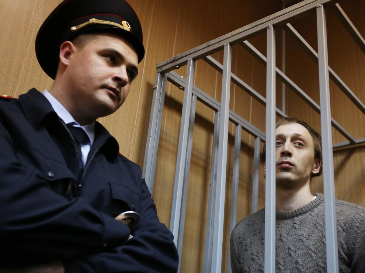 Bolshoi ballet soloist and defendant Pavel Dmitrichenko is shown standing in the courtroom cage Tuesday as his case went to trial in Moscow.